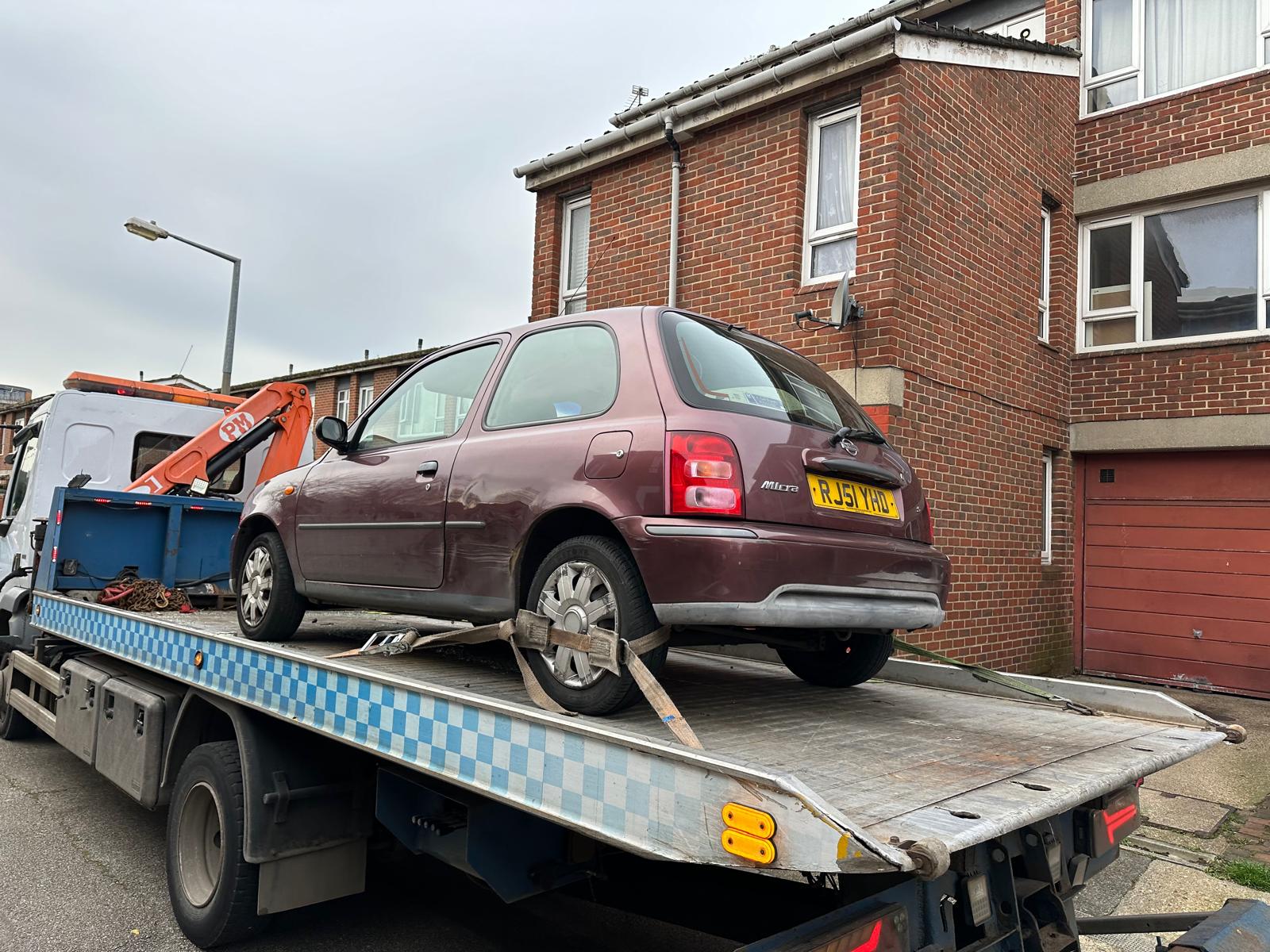 Nissan Micra on the back of a recovery truck