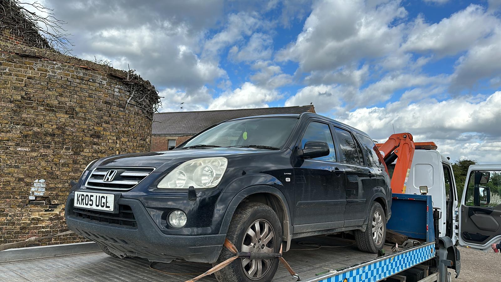 Honda on the flatbed of a recovery truck Honda on the flatbed of a recovery truck