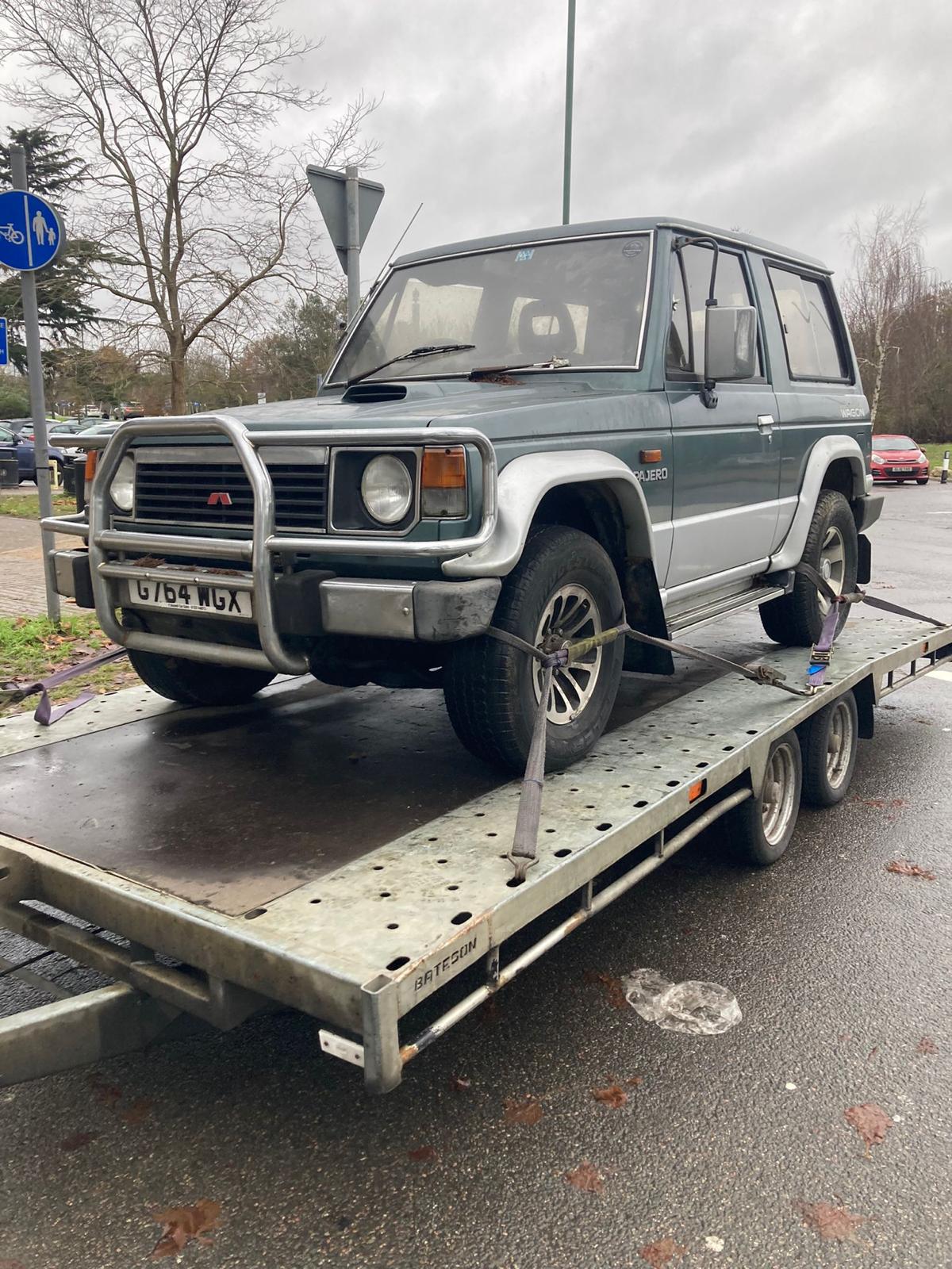 Broken down Mitsubishi on trailer Broken down Mitsubishi on trailer