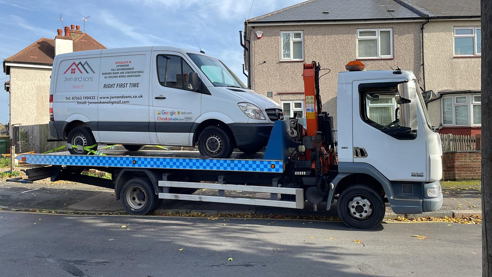 Broken down van on a recovery flatbed Broken down van on a recovery flatbed